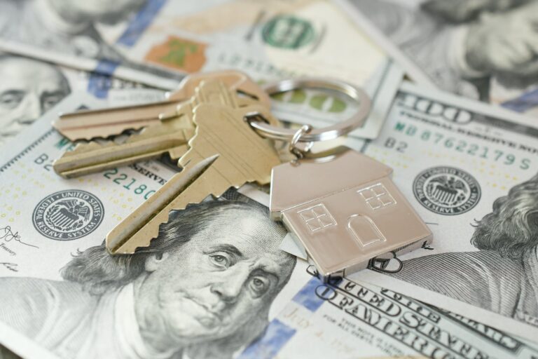 Housing Market concept - house keys on money currency, real estate, home loan, equity buy sell